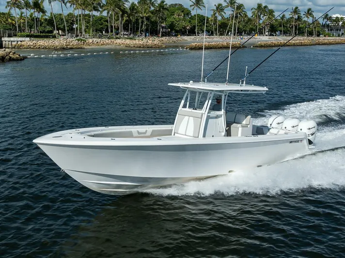 Baker Acted Yacht Photos Pics 2020 Contender 35ST boat cruising on water near palm trees.