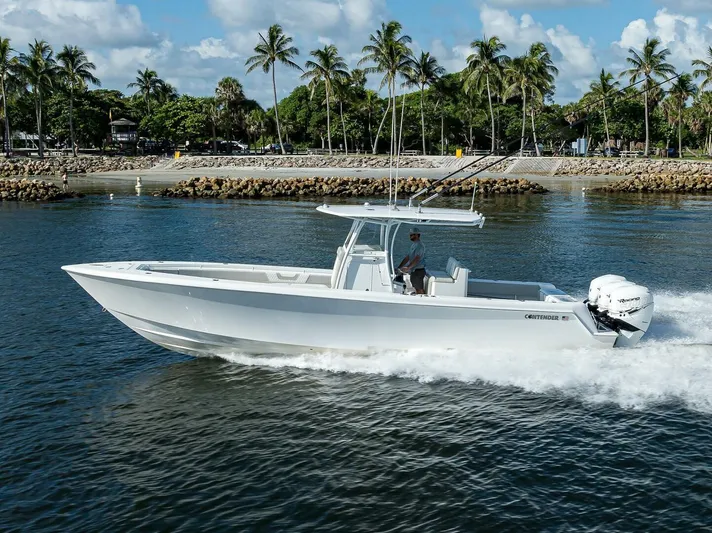 Baker Acted Yacht Photos Pics 2020 Contender 35ST boat cruising on water near a tropical shoreline.