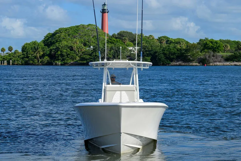 Baker Acted Yacht Photos Pics 2020 Contender 35ST boat on water with lighthouse and greenery in background.