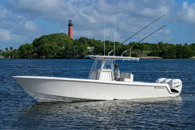 Baker Acted Yacht Photos Pics 2020 Contender 35ST boat cruising on water near a lighthouse.