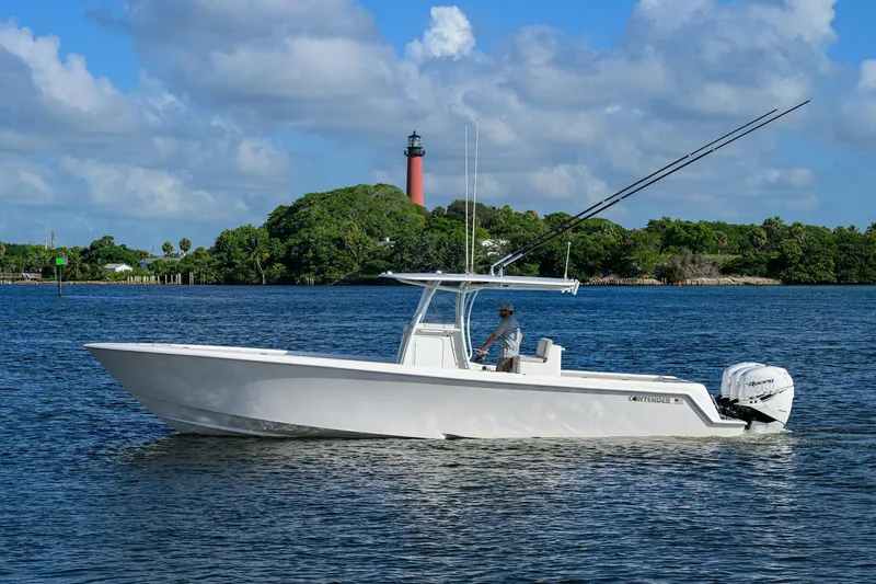 Baker Acted Yacht Photos Pics 2020 Contender 35ST boat on water with lighthouse in background.