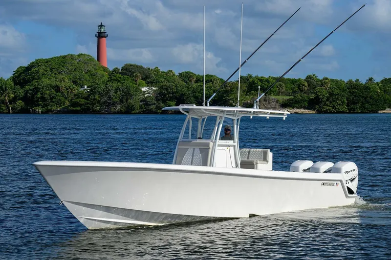 Baker Acted Yacht Photos Pics 2020 Contender 35ST boat cruising on water near a lighthouse.