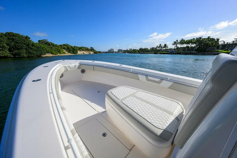 Baker Acted Yacht Photos Pics 2020 Contender 35ST boat on a scenic waterway with lush greenery.