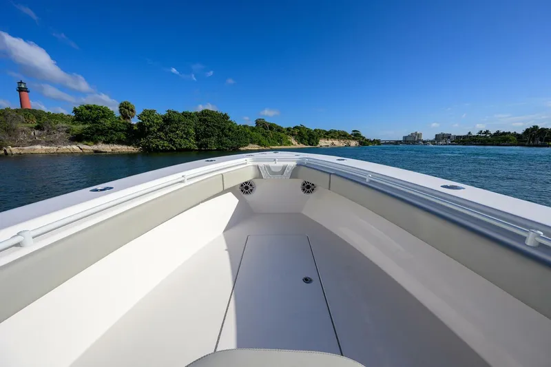 Baker Acted Yacht Photos Pics 2020 Contender 35ST boat cruising on a scenic waterway with lush greenery.