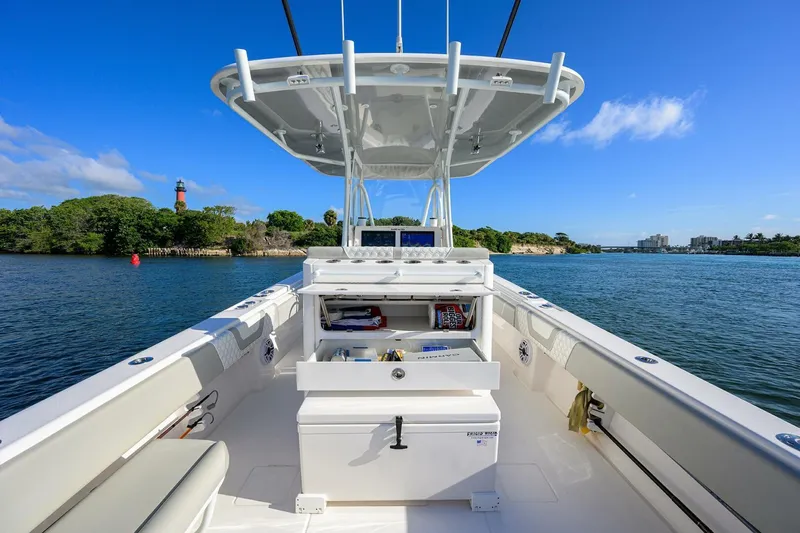 Baker Acted Yacht Photos Pics 2020 Contender 35ST boat on calm water with open storage compartments.