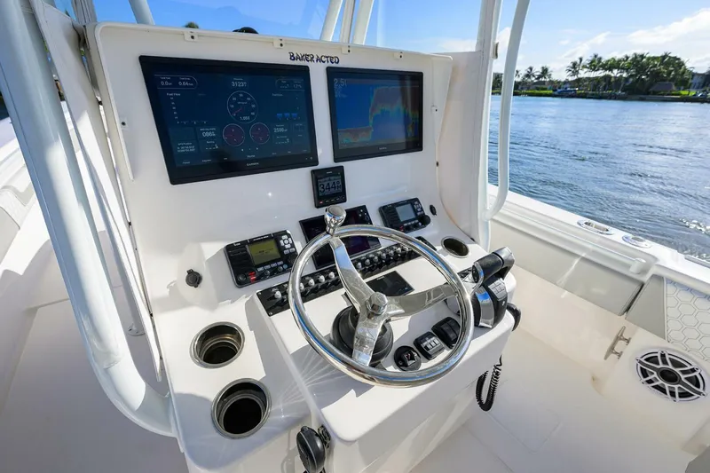 Baker Acted Yacht Photos Pics Contender 35ST 2020 boat dashboard with dual screens and steering wheel on a sunny day.