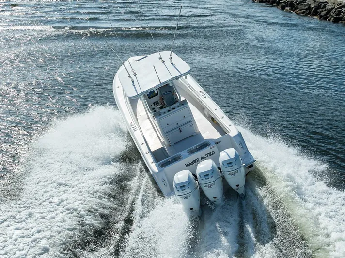 Baker Acted Yacht Photos Pics 2020 Contender 35ST boat cruising on water with triple outboard engines.