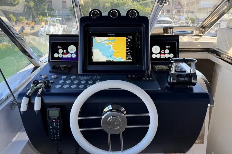  Yacht Photos Pics Cockpit of 2021 Itama 45 S yacht with navigation controls and display screens.