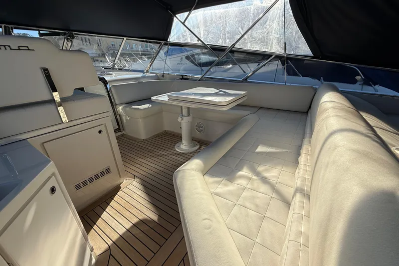  Yacht Photos Pics Luxurious interior of 2021 Itama 45 S yacht with elegant seating and wooden flooring.
