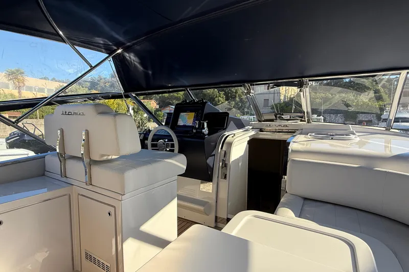  Yacht Photos Pics Interior of 2021 Itama 45 S yacht with luxurious seating and navigation controls.