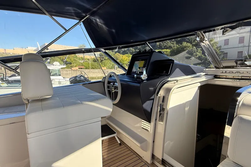  Yacht Photos Pics Interior of 2021 Itama 45 S yacht, featuring sleek helm and luxurious seating.
