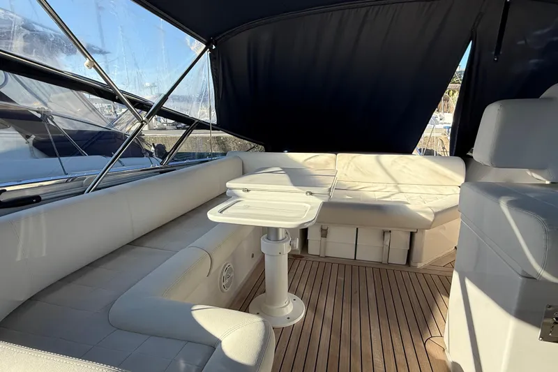  Yacht Photos Pics Luxurious interior of 2021 Itama 45 S yacht with white seating and wooden flooring.