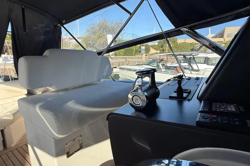  Yacht Photos Pics Interior view of 2021 Itama 45 S yacht cockpit with controls and seating.