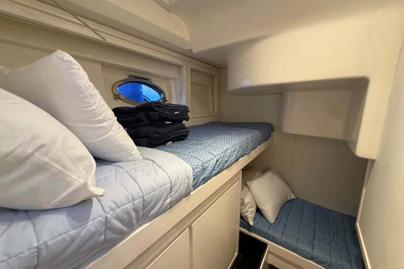  Yacht Photos Pics Cozy cabin interior of 2021 Itama 45 S yacht with bunk beds and porthole.