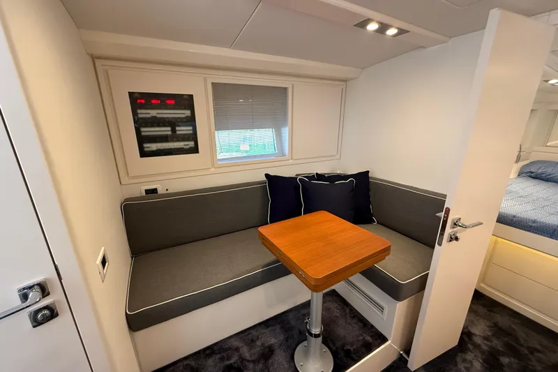  Yacht Photos Pics Interior of 2021 Itama 45 S yacht with cozy seating and wooden table.