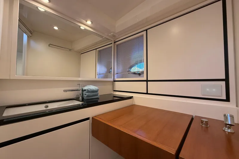  Yacht Photos Pics Modern bathroom interior of 2021 Itama 45 S yacht with sleek design and wooden accents.