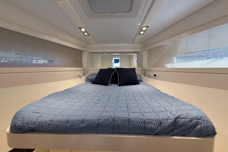  Yacht Photos Pics Luxurious cabin interior of 2021 Itama 45 S yacht with a cozy bed.