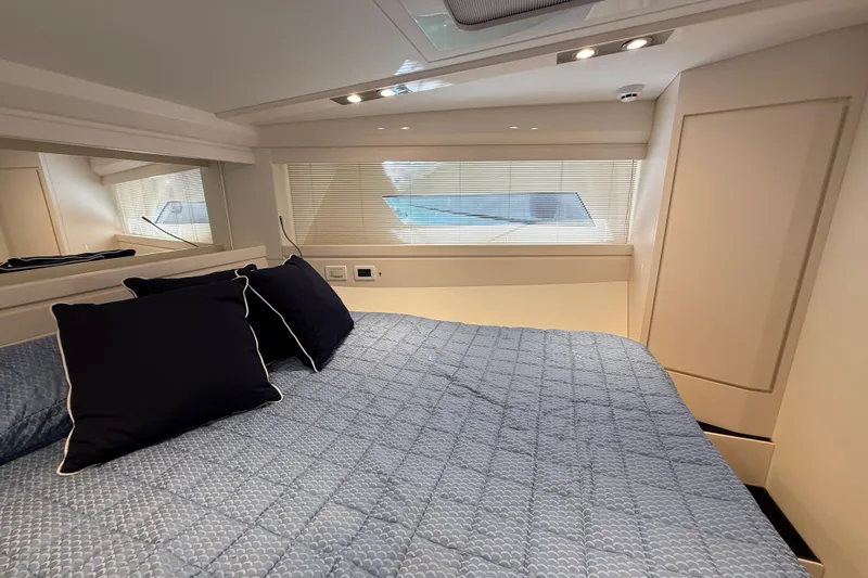  Yacht Photos Pics Luxurious cabin interior of 2021 Itama 45 S yacht with elegant bedding and modern design.