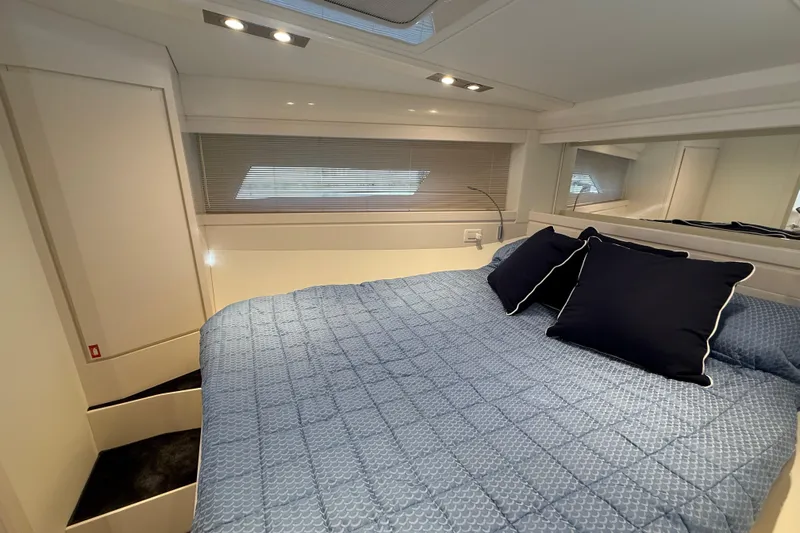  Yacht Photos Pics Luxurious cabin interior of 2021 Itama 45 S yacht with blue bedding and modern design.