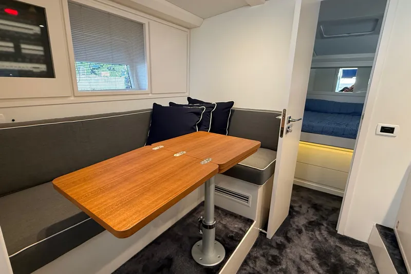  Yacht Photos Pics Interior of 2021 Itama 45 S yacht with cozy seating and wooden table.