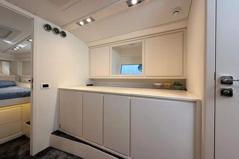  Yacht Photos Pics Luxurious interior of 2021 Itama 45 S yacht with modern cabinetry and cozy bedroom.