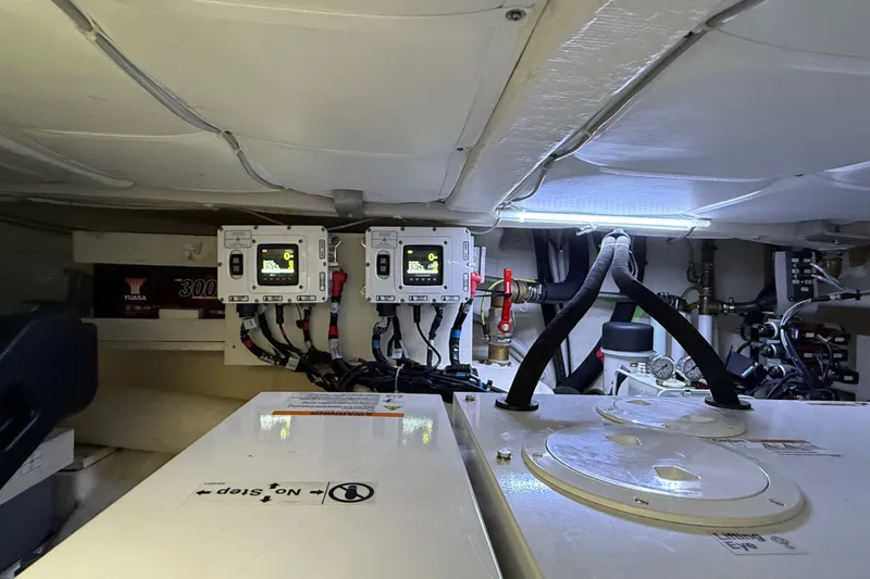  Yacht Photos Pics Engine room of a 2021 Itama 45 S yacht with control panels and wiring.