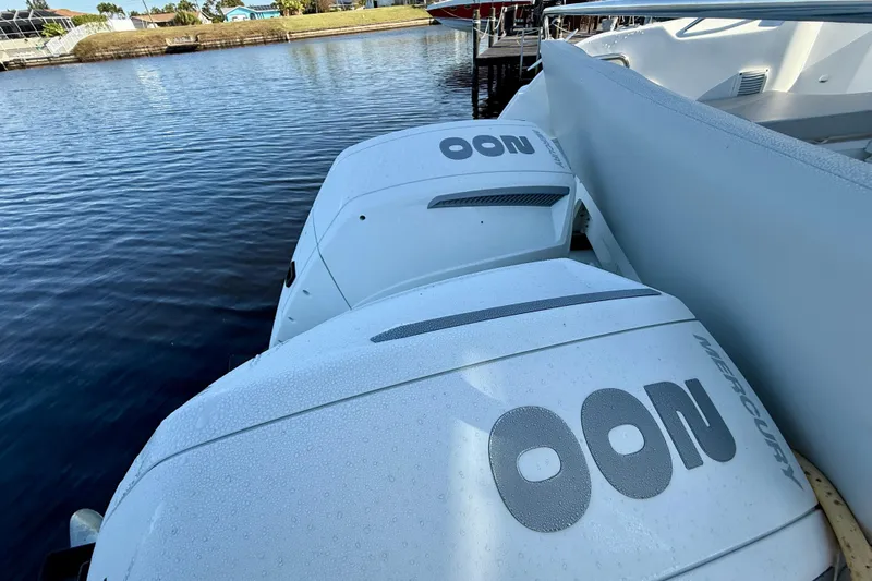  Yacht Photos Pics Twin Mercury outboard engines on a 2022 Beneteau Antares 9, docked by the water.