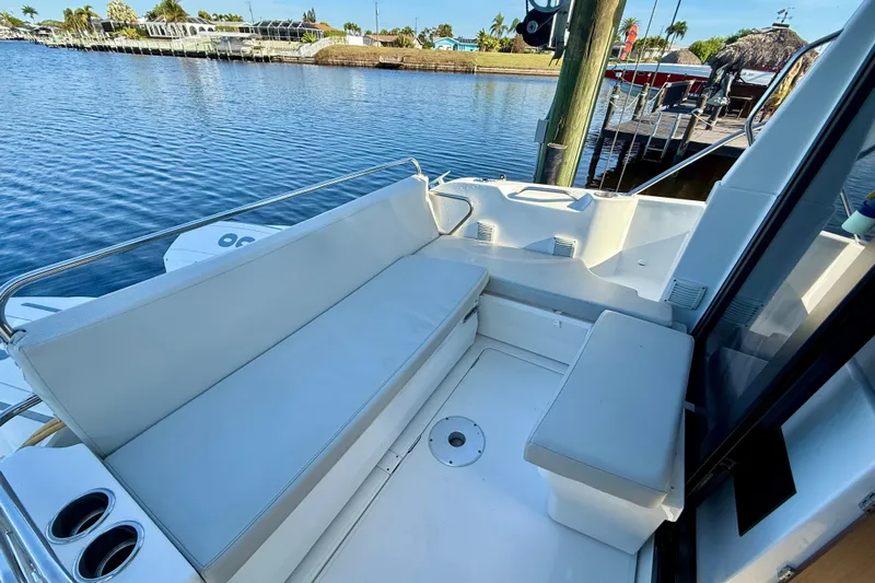  Yacht Photos Pics 2022 Beneteau Antares 9 boat with spacious seating area by the water.