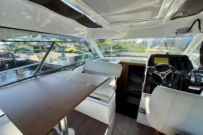  Yacht Photos Pics Interior of 2022 Beneteau Antares 9 boat with modern helm and seating area.