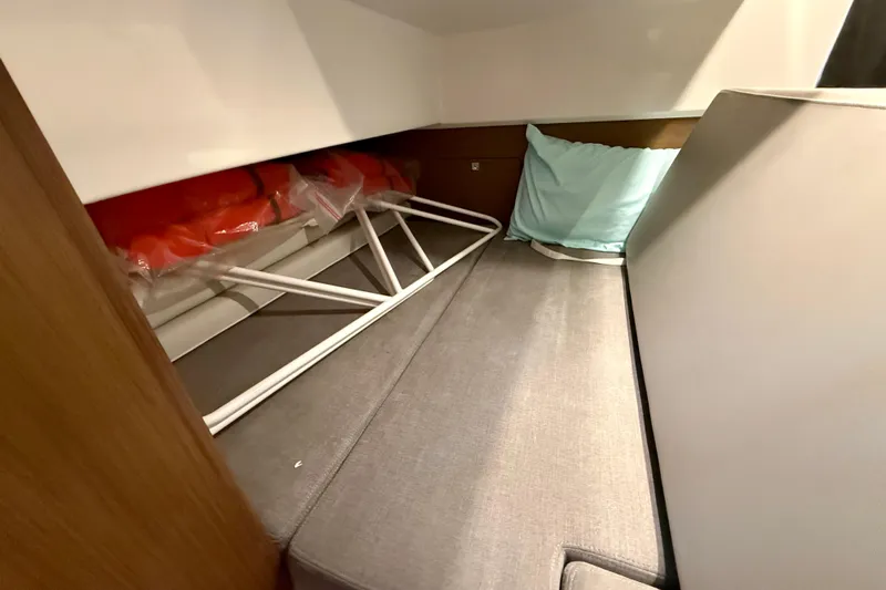 Yacht Photos Pics Interior cabin of 2022 Beneteau Antares 9 with storage and cushions.