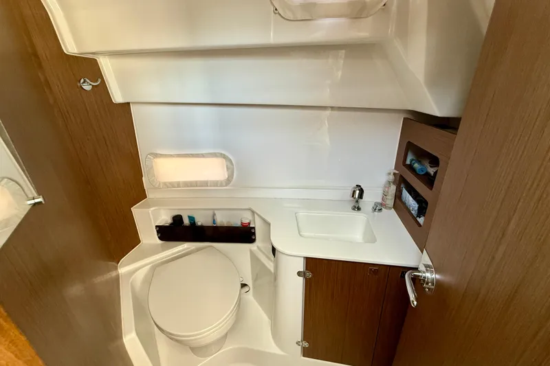  Yacht Photos Pics Bathroom interior of 2022 Beneteau Antares 9 boat, featuring sink and toilet.