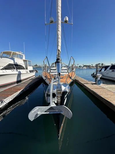 Dharma Yacht Photos Pics 2013 Jeanneau 57 yacht docked at marina under clear blue sky.