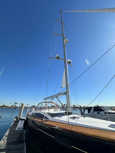 Dharma Yacht Photos Pics 2013 Jeanneau 57 sailboat docked under clear blue sky.