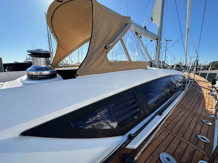 Dharma Yacht Photos Pics 2013 Jeanneau 57 sailboat with tan canopy and sleek deck design.