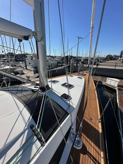 Dharma Yacht Photos Pics 2013 Jeanneau 57 sailboat docked at marina, showcasing deck and rigging.