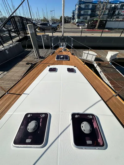 Dharma Yacht Photos Pics 2013 Jeanneau 57 yacht deck with hatches, docked in marina.
