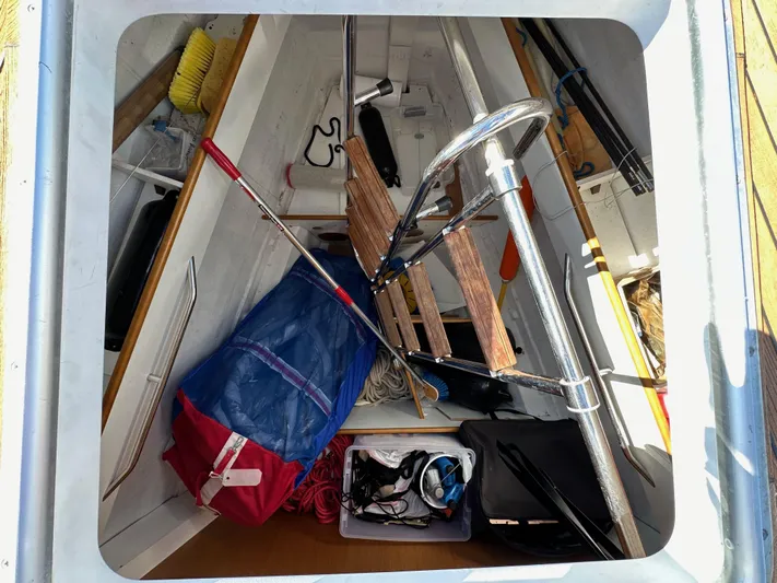 Dharma Yacht Photos Pics Storage compartment of a 2013 Jeanneau 57 sailboat with various equipment and gear.