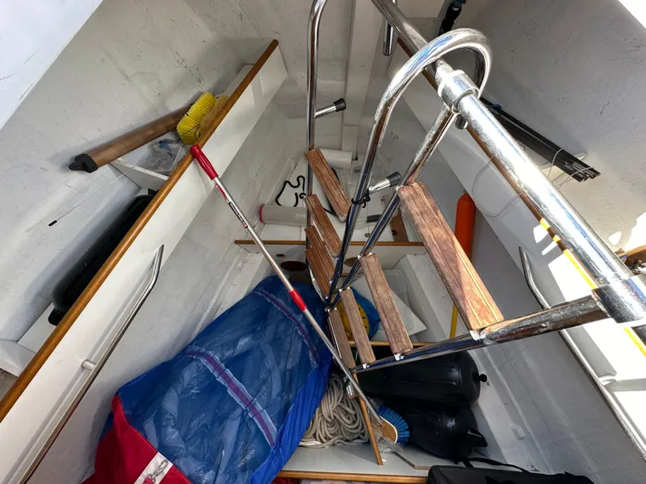 Dharma Yacht Photos Pics Interior storage of 2013 Jeanneau 57 sailboat with equipment and ladder.