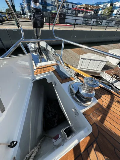 Dharma Yacht Photos Pics 2013 Jeanneau 57 sailboat deck with winch and storage compartment.