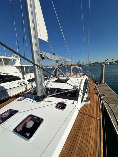 Dharma Yacht Photos Pics 2013 Jeanneau 57 yacht docked, showcasing sleek deck and mast under clear blue sky.