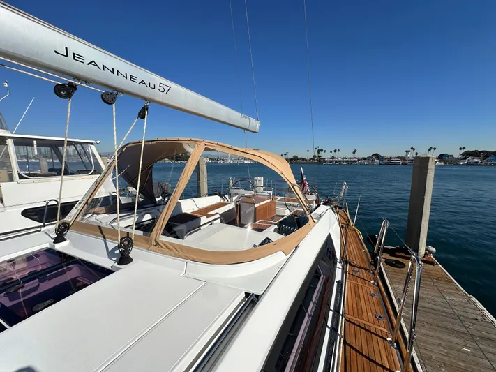 Dharma Yacht Photos Pics 2013 Jeanneau 57 yacht docked, featuring sleek design and spacious deck.