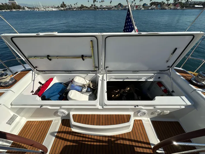 Dharma Yacht Photos Pics Open storage compartments on 2013 Jeanneau 57 yacht deck, with gear and equipment visible.