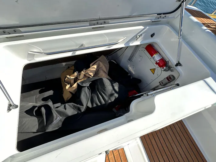 Dharma Yacht Photos Pics Storage compartment on a 2013 Jeanneau 57 yacht with safety equipment and gear.