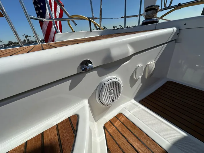 Dharma Yacht Photos Pics Jeanneau 57 yacht deck, 2013 model, featuring teak flooring and audio speaker.