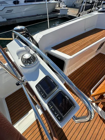 Dharma Yacht Photos Pics Jeanneau 57 yacht cockpit with navigation instruments, teak flooring, and steering wheel, 2013 model.