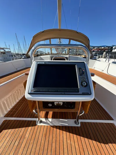 Dharma Yacht Photos Pics 2013 Jeanneau 57 yacht helm with navigation system and teak deck.