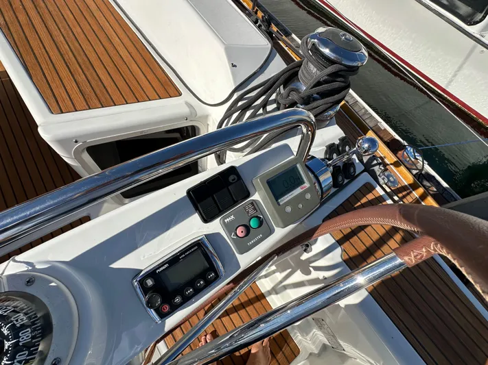 Dharma Yacht Photos Pics Jeanneau 57 yacht cockpit controls, 2013 model, featuring navigation instruments and teak decking.