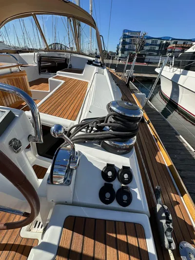 Dharma Yacht Photos Pics 2013 Jeanneau 57 sailboat deck with winches and teak finish in marina.