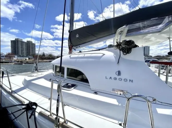 Blue Mind Yacht Photos Pics 2018 Lagoon 380 S2 catamaran docked under a bright blue sky.