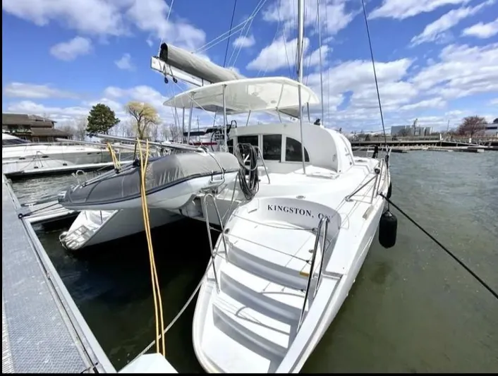 Blue Mind Yacht Photos Pics 2018 Lagoon 380 S2 catamaran docked at marina under blue sky.